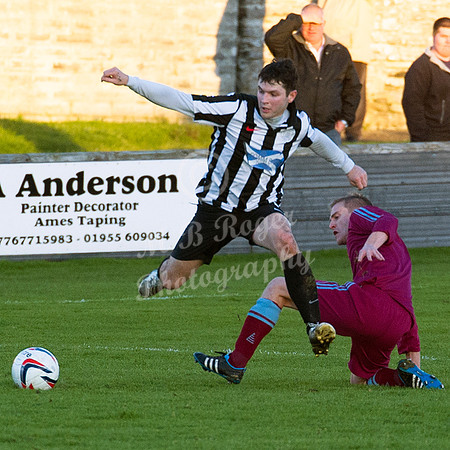 Highland League (SHFL) football match Wick Academy FC and Keith FC played at Harmsworth Park Wick home of the Scorries.  Wick's Sam Mackay hurdles the challenge of Bruce Raffell