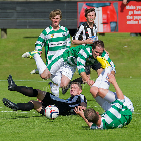 Buckie's Iain MacRae flying thu air after a tackle by Wick's Michael Steven