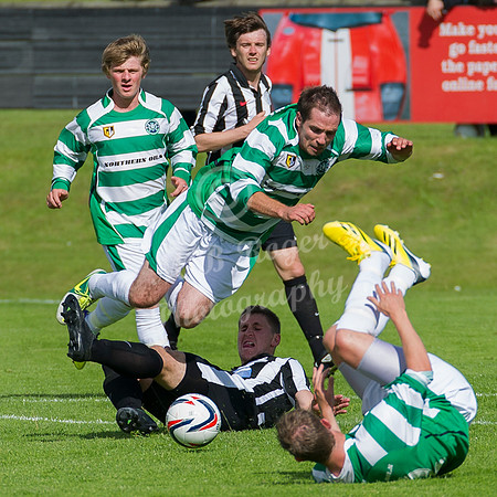 Buckie's Iain MacRae is caught by tackle from Wick's Michael Steven