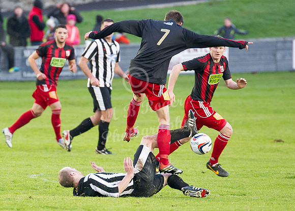 Wick 2 v Inverurie 2  SHFL 23/11/2013<br/>Inverurie's John Maitland takes evasive action as Wick's Craig Sheaer slides through