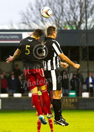 Wick 2 v Inverurie 2  SHFL 23/11/2013<br/>Wick's Lukasz Geruzel rises above Kieran Adams of Inverurie to head the ball