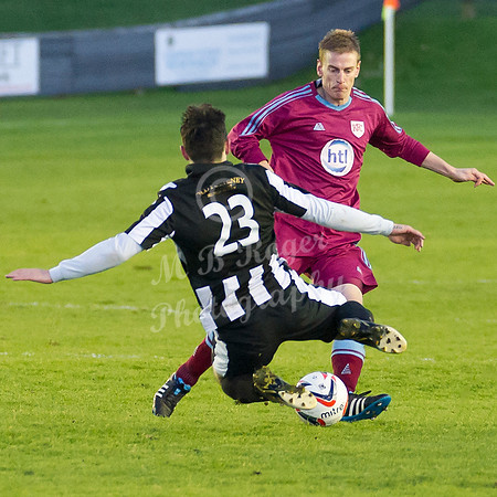 Highland League (SHFL) football match Wick Academy FC and Keith FC played at Harmsworth Park Wick home of the Scorries.  Wick's Sam Mackay launches himself into the tackle on Keith's Bruce Raffell