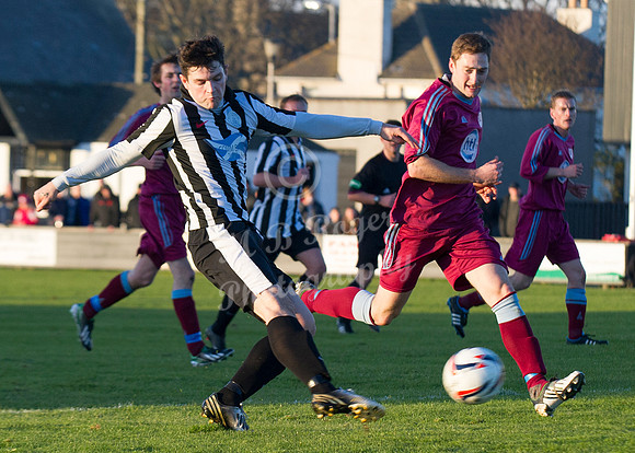 Highland League (SHFL) football match Wick Academy FC and Keith FC played at Harmsworth Park Wick home of the Scorries.  A shot by Wick's Sam Mackay watched by Keith's Mark Wood