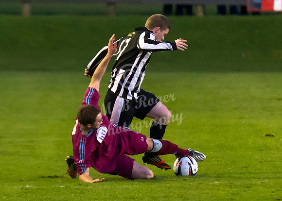 Highland League (SHFL) football match Wick Academy FC and Keith FC played at Harmsworth Park Wick home of the Scorries.  Keith's Mark Wood times his tackle to nick the ball from the toe of Wick's Ross