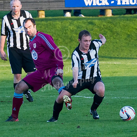 Highland League (SHFL) football match Wick Academy FC and Keith FC played at Harmsworth Park Wick home of the Scorries.  Wick's Richard MacAdie has his leg hooked by Keith's Stuart Walker