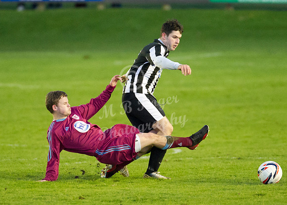 Highland League (SHFL) football match Wick Academy FC and Keith FC played at Harmsworth Park Wick home of the Scorries.  Keith's Zander Jack miss times his tackle on Wick's Sam Mackay